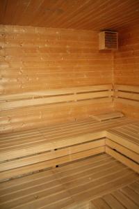 a wooden sauna with wooden floors and a ceiling at Hotel Bouček in Mochov