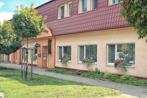 a building with flower boxes on the windows at Hotel U Kašny in Rajhrad