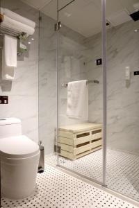 a bathroom with a shower and a toilet at Bridal Tea House Hotel-Free Welcome Drink in Guangzhou