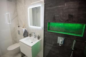 a bathroom with a sink and a toilet and a mirror at Condo Spalato in Split +46 photos