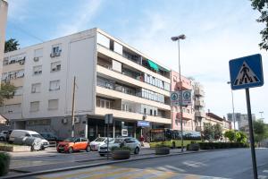 a street with cars parked in front of a building at Condo Spalato in Split