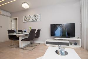 a living room with a dining table and a television at Condo Spalato in Split