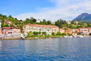 a group of buildings on the shore of a body of water at Grand Hotel Menaggio in Menaggio
