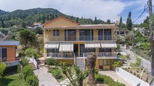 an image of a house with a mountain in the background at Gardelis Gardens in Benitses