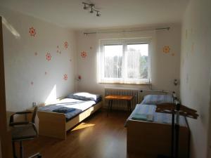 a bedroom with two beds and a window at Apartment Pražská in Rokycany
