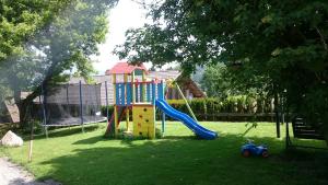 a playground with a slide in a yard at Haus Maria in Arnoldstein