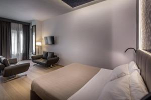 A bed or beds in a room at Blu Notte Guest House