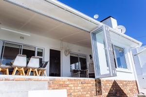 a sliding glass door on a house with chairs at 16 Mile View in Yzerfontein +68 photos