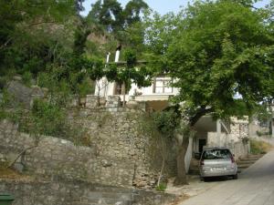 a car parked in front of a stone wall at Kria springs in Livadeia