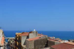 a view of roofs of buildings and the ocean at Il Corallo in Castellammare del Golfo