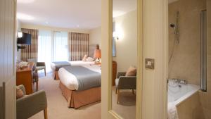 a hotel room with a bed and a bathroom at Marwell Hotel Winchester South in Winchester +18 photos