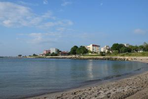 a body of water with buildings in the background at Apartament ALBATROS in Mangalia