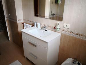 łazienka z umywalką, lustrem i toaletą w obiekcie Apartamento AGRELO w mieście Bueu +20 zdjęć