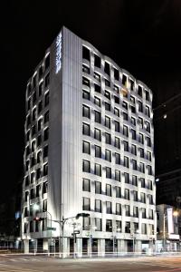 a large white building at night with a street at Starhaus Hotel in Kaohsiung