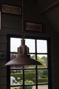 a pendant light hanging in front of a window at Boven-Langs in Diepenheim