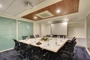 a conference room with a large table and chairs at White Castle Boutique Apartment Hotel in Bangalore