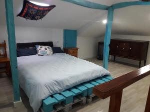 a bedroom with a bed with a blue canopy at El Cuetu in Posada