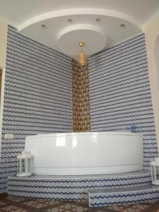 a bathroom with a white tub in a room at Hotel Elita in Odesa