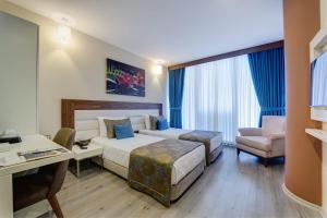Postel nebo postele na pokoji v ubytování Forum Suite Otel