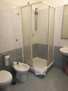 a bathroom with a shower and a toilet and a sink at In Rome in Rome