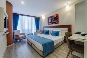 Postel nebo postele na pokoji v ubytování Forum Suite Otel