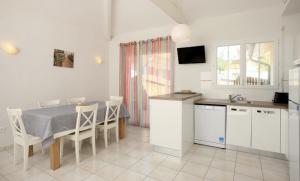 a kitchen with a table and chairs in a room at Residence Plage Oceane in Biscarrosse-Plage