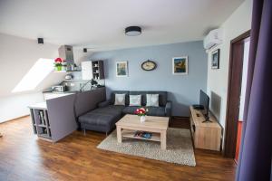 a living room with a couch and a table at Apartmány u sv. Kryštofa in Bzenec