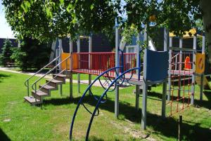 a park with a playground with a slide at Camping Marco Polo in Łeba