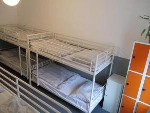 two bunk beds in a room next to a wall at Hostel Franz Kafka in Prague