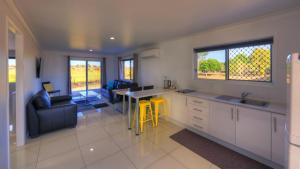 a kitchen and living room with a couch and a table at Heritage Lodge Motel in Charters Towers