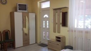 a living room with a tv on top of a door at Pál utcai Apartman Miskolc in Miskolc