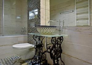 a bathroom with a sink and a toilet at Dali ApartHOTEL in Koszalin