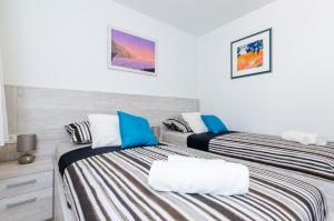 Ein Bett oder Betten in einem Zimmer der Unterkunft Apartments Lazarin
