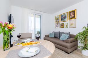 a living room with a table and a couch at Apartments Lazarin in Dubrovnik