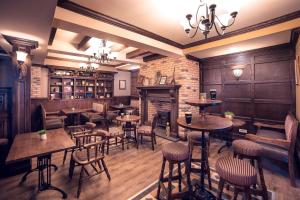 a restaurant with tables and chairs and a bar at The Frontier Hotel in Siret