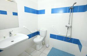 a bathroom with a sink and a toilet and a shower at Residence Plage Oceane in Biscarrosse-Plage