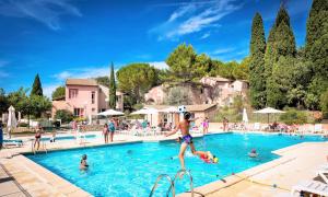 a group of people in a swimming pool at Village-vacances de Vaison la Romaine in Vaison-la-Romaine