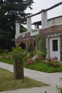 a brick building with flowers in front of it at Podere San Marco in Bonate di Sopra