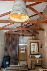 a bathroom with a sink and a large ceiling at Mirabel Guesthouse in Parys