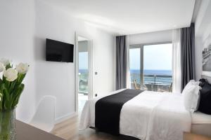 a hotel room with a view of the ocean at Poseidon Athens Hotel in Athens