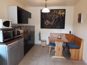 a kitchen with a wooden table in a kitchen at la clairiere in Sarlat-la-Canéda