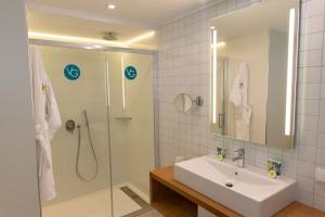 a bathroom with a sink and a shower at Vanilla Garden Boutique Hotel - Adults Only in Playa de las Americas