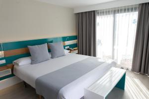 a large white bed in a room with a window at Vanilla Garden Boutique Hotel - Adults Only in Playa de las Americas