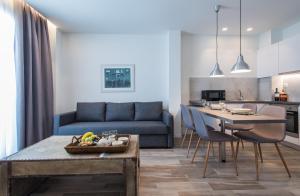 a living room with a blue couch and a table at Spot Apart in Athens