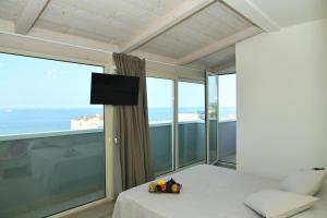 a bedroom with a bed and a balcony with the ocean at Hotel Gala in Misano Adriatico +121 photos