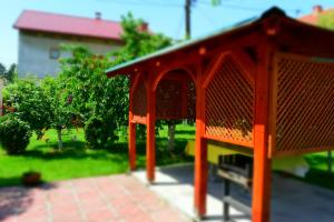 an orange bird house sitting in a yard at Villa AMANI in Sarajevo