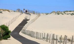 a fence in the sand on a beach at Residence Plage Oceane in Biscarrosse-Plage