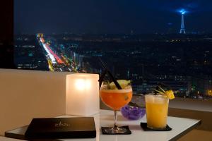 
a glass of orange juice sitting on top of a table at Melia Paris La Defense in Courbevoie
