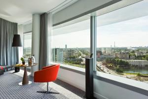 
a living room filled with furniture and a window at Melia Paris La Defense in Courbevoie
