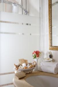 a bathroom with a basket of towels and a sink at Tenuta Del Perugino in Bettona